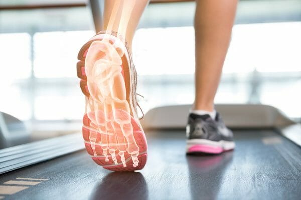 Digital composite of Highlighted foot of woman on treadmill